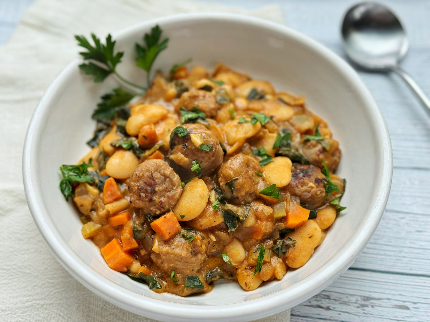 SEARED BRATWURST WITH CREAMY WHITE BEANS & GREENS